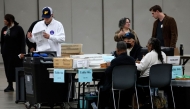 Workers process absentee ballots for the 2024 General Election at Huntington Place on November 5, 2024 in Detroit, Michigan. (Photo by JEFF KOWALSKY / AFP)
