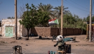 A stuffed panda and a Sudanese flag are placed at a military checkpoint in Khartoum North on November 3, 2024. Sudan's war erupted in April 2023 between the regular army led by Burhan and the paramilitary Rapid Support Forces (RSF), led by his former deputy, Mohamed Hamdan Daglo. (Photo by Amaury Falt-Brown / AFP)
