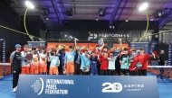 Players celebrate with their trophies.