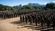 (FILES) This photo taken on November 9, 2024 shows members of Ta'ang National Liberation Army (TNLA) receiving military equipments at a graduation ceremony after getting special combat training for three months in a secret jungle near Namhkam, Myanmar's northern Shan State. (Photo by AFP)
