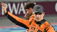 McLaren's Australian driver Oscar Piastri waves to the crowd after winning the sprint race ahead of the Qatari Formula One Grand Prix. 