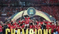 Ahly players celebrate with the winner's trohpy after winning the second leg of the CAF Champions League final football match between Egypt's Al-Ahly and Tunis' Esperance Sportive de Tunis at the Cairo International stadium on May 25, 2024. (Photo by Khaled DESOUKI / AFP)