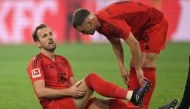 Bayern Munich's English forward #09 Harry Kane (L) speaks with Bayern Munich's German midfielder #06 Joshua Kimmich after an injury during the German first division Bundesliga football match between BVB Borussia Dortmund and FC Bayern Munich in Dortmund, western Germany on November 30, 2024. (Photo by INA FASSBENDER / AFP) 