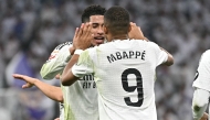 Real Madrid's French forward #09 Kylian Mbappe celebrates with teammates scoring his team's second goal during the Spanish league football match between Real Madrid CF and Getafe CF at the Santiago Bernabeu stadium in Madrid on December 1, 2024. (Photo by JAVIER SORIANO / AFP)
