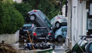 This photograph shows cars piled on top of each other in the city of Rhodes after heavy rainfall, on the Greek island of Rhodes, on December 1, 2024. (Photo by STRINGER / Eurokinissi / AFP)
