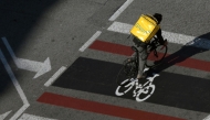 (Files) A Glovo delivery worker rides in Barcelona on February 4, 2021. (Photo by Lluis Gene / AFP)