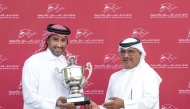 QREC Racing Manager Abdulla Rashid Al Kubaisi presents the trophy to representative of Wathnan Racing after Supercooled won the Thoroughbred Derby Trial.