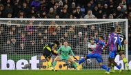 Manchester City's English defender #82 Rico Lewis (L) shoots the ball and scores his team second goal past Crystal Palace's English goalkeeper #01 Dean Henderson during the English Premier League football match between Crystal Palace and Manchester City at Selhurst Park in south London on December 7, 2024. (Photo by Glyn KIRK / AFP) 
