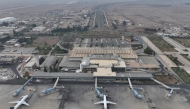 An aerial view shows passenger planes of Syria's private airline company Cham Wings on the tarmac of the closed international airport of Damascus on December 11, 2024.  (Photo by Omar Haj Kadour / AFP)