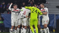 Manchester United players celebrate after Manchester United's Danish striker #09 Rasmus Hojlund (hidden) scored a goal during the UEFA Europa League football match between Viktoria Plzen and Manchester United in Plzen, Czech Republic on December 12, 2024. (Photo by Michal Cizek / AFP)