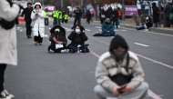 Demonstrators sit on a road as they take part in a protest calling for the ouster of South Korea President Yoon Suk Yeol on a road near the National Assembly in Seoul on December 13, 2024. Photo by Jung Yeon-je / AFP.

