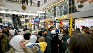 People shop at a shopping mall in the town of al-Dana, near Sarmada, in the northern Syrian province of Idlib on December 13, 2024. The crowd wanders in awe through the aisles saturated with lights, dazzled by the abundance of goods displayed before them in the heart of the former rebel stronghold in northwestern Syria. Photo by OZAN KOSE / AFP.