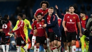 Manchester United's Portuguese midfielder #08 Bruno Fernandes (2nd left) Manchester United's Dutch striker #11 Joshua Zirkzee (centre) and Manchester United's Danish striker #09 Rasmus Hojlund (2nd right) celebrate following the English Premier League football match between Manchester City and Manchester United at the Etihad Stadium in Manchester, north west England, on December 15, 2024. (Photo by Paul Ellis / AFP)
