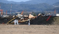 File photo of recovery teams working at the scene where a Jeju Air Boeing 737-800 series aircraft crashed and burst into flames at Muan International Airport in Muan. Photo by Jung Yeon-Je / AFP.