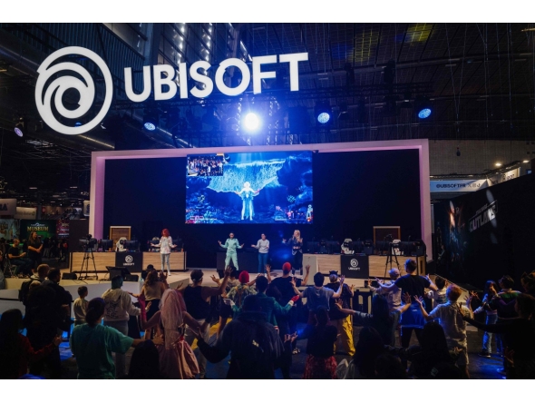 Visitors dance at the Ubisoft stand during the Paris Games Week fair in Paris, on October 23, 2024. Photo by Dimitar DILKOFF / AFP

