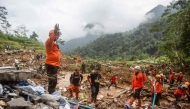 Rescue teams, including Indonesia's National Search and Rescue Agency (BASARNAS), the army, police, and volunteers, use high-pressure water to search for victims of a landslide triggered by heavy rain two days ago, which has so far claimed 19 lives, in Kasimpar Village, Central Java, on January 22, 2025. (Photo by DEVI RAHMAN / AFP)
