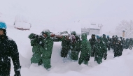 In this handout photo taken and released by the State Disaster Response Force (SDRF) on February 28, 2025, rescuers carry Border Roads Organisation (BRO) workers after an avalanche near Mana village in Chamoli district. Photo by State Disaster Response Force (SDRF) / AFP.