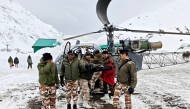 In this handout photograph taken on March 1, 2025 and released by the Department of Information and Public Relations (DIPR) Uttarakhand, security personnel carry a victim onto a helicopter during a rescue operation, a day after an avalanche hit a Border Roads Organisation (BRO) construction camp, as workers remain trapped under snow and debris near Mana village in the Chamoli district of India's Uttarakhand state. Photo by Department of Information and Public Relations (DIPR) Uttarakhand / AFP
