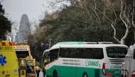 Emergency services members stand next to a bus after two buses collided in Barcelona on March 3, 2025. Photo by Manaure Quintero / AFP