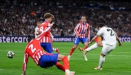 Real Madrid's Moroccan forward #21 Brahim Diaz (R) scores his team's second goal during the UEFA Champions League Round of 16 first leg football match between Real Madrid CF and Club Atletico de Madrid at the Santiago Bernabeu stadium in Madrid, on March 4, 2025. (Photo by Thomas COEX / AFP)
