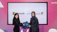 Assistant Undersecretary for Digital Industry Affairs at MCIT Reem Al Mansoori, and General Manager of Microsoft Qatar Lana Khalaf exchanging documents after signing the agreement.