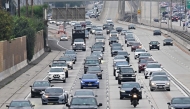 A motorcyclist is seen among drivers during the Los Angeles evening rush hour commute on March 26, 2025 in Alhambra, California. (Photo by Frederic J. BROWN / AFP)