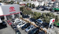 (FILES) In an aerial view, cars sit in a lot at the San Francisco Toyota service center on May 11, 2022 in San Francisco, California. (Photo by JUSTIN SULLIVAN / GETTY IMAGES NORTH AMERICA / AFP)
