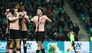 (from L) Paris Saint-Germain's French forward #29 Bradley Barcola, Paris Saint-Germain's French forward #10 Ousmane Dembele and Paris Saint-Germain's Portuguese midfielder #87 Joao Neves celebrate their sixth goal during the French L1 football match between AS Saint-Etienne and Paris Saint-Germain (PSG) at the Geoffroy-Guichard stadium in Saint-Etienne, central France on March 29, 2025. (Photo by Alex MARTIN / AFP)
