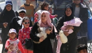 People fleeing Rafah arrive in Khan Yunis city following new Israeli evacuation orders, in the southern Gaza Strip, on March 31, 2025. (Photo by Eyad BABA / AFP)
