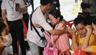 Photo used for representational purposes. People react while waiting for news of missing loved ones at the site of an under-construction building collapse in Bangkok on April 1, 2025, four days after an earthquake struck central Myanmar and Thailand. Photo by Lillian SUWANRUMPHA / AFP.