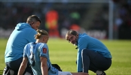 Manchester City's Norwegian striker #09 Erling Haaland receives medical attention after picking up an injury during the English FA Cup quarter-final football match between Bournemouth and Manchester City at the Vitality Stadium in Bournemouth, on the south coast of England on March 30, 2025. (Photo by JUSTIN TALLIS / AFP)