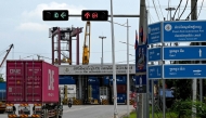 A truck transports a container toward the entrance of the Phnom Penh Autonomous Port on April 3, 2025. Photo by TANG CHHIN Sothy / AFP