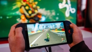 (FILES) A guest plays Mariokart World with the new Nintendo Switch 2 video-game console system of Japanese video-game company Nintendo during the worldwide presentation at the Grand Palais in Paris on April 2, 2025. (Photo by Dimitar DILKOFF / AFP)
