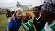 South African Vuka Soweto team players interact with a French team member after their quarter final match during the Grannies International Football Tournament 2025 at Nkowankowa stadium in Tzaneen on April 4, 2025. (Photo by Phill Magakoe / AFP)