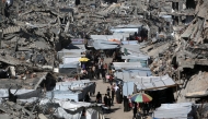 This aerial view shows Palestinians gathered at a makeshift market set up in the midst of a war devastated neighbourhood in the Jabalia refugee camp in the northern Gaza Strip on April 2, 2025. Photo by Bashar TALEB / AFP