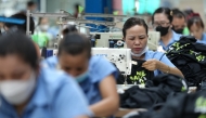 Vietnamese garment factory workers stitch apparel at a factory in Ho Chi Minh City on April 3, 2025, after US President Donald Trump unveiled sweeping new tariffs on trading partners. Photo by Huu Kha / AFP