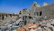 People inspect the site of a reported US airstrike in Sanaa, a day after the attack, on April 7, 2025. (Photo by Mohammed HUWAIS / AFP)
