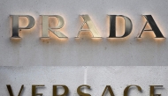 This combination of pictures created on April 10, 2025 shows a file picture of a logo outside the fashion house and luxury goods Versace shop on the Avenue Montaigne in Paris. Photo by STEPHANE DE SAKUTIN / AFP