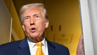 US President Donald Trump speaks to reporters during the flight from Palm Beach to Miami aboard Air Force One on April 12, 2025. Photo by Mandel NGAN / AFP