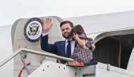 U.S. Vice President JD Vance disembarks Air Force Two while carrying his daughter Mirabel, upon arriving at Rome Ciampino Airport, on April 18, 2025. The US Vice President will meet with Prime Minister Giorgia Meloni and will also meet with Vatican Secretary of State Cardinal Pietro Parolin. (Photo by Kenny HOLSTON / POOL / AFP)