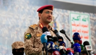 Brigadier Yahya Saree Qasim, the spokesman for Yemen's Houthis, speaks during a protest to denounce US airstrikes on Yemen, in Sanaa on April 18, 2025. (Photo by MOHAMMED HUWAIS / AFP)
