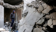 A man looks through the rubble to inspect a destroyed building that was hit by Israeli bombardment in Jabalia in the northern Gaza Strip on April 18, 2025.  (Photo by Bashar Taleb / AFP)
