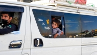 Photo used for representational purposes. A policeman escorts a van carrying Afghan refugees from a camp in Panjpai area on the outskirts of Quetta on April 16, 2025. Photo by Banaras KHAN / AFP.
