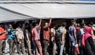 Refugees who crossed from Sudan to Ethiopia wait in line to register at IOM (International organization for Migration) in Metema, on May 4, 2023. (Photo by Amanuel Sileshi / AFP)