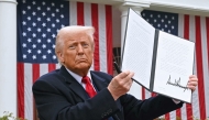 (FILES) US President Donald Trump holds a signed executive order after delivering remarks on reciprocal tariffs during an event in the Rose Garden entitled 