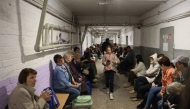 Local residents take cover in an underground shelter during a Russian missile attack in Kyiv early on April 24, 2025. (Photo by Stringer / AFP)