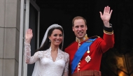 Britain's Prince William and his wife Kate, Duchess of Cambridge, wave to the crowd from the balcony of Buckingham Palace in London on April 29, 2011, following their wedding. (Photo by John Stillwell / POOL / AFP)
