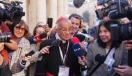 Colombian cardinal Jorge Enrique Jiménez Carvajal (C) speaks to the press as he arrives for the seventh congregation meeting at The Vatican, on April 30, 2025. (Photo by Dimitar DILKOFF / AFP)