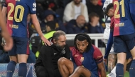 Medical staff's member tends to Barcelona's French defender #23 Jules Kounde during the UEFA Champions League semi final first leg football match between FC Barcelona and Inter Milan at the Estadi Olimpic Lluis Companys in Barcelona on April 30, 2025. (Photo by Josep LAGO / AFP)