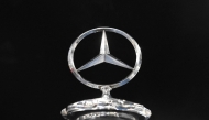 This photograph taken on November 21, 2024 shows a Mercedes star on the radiator of a classic car in the Mercedes-Benz Classic Center in Fellbach, southern Germany. Photo by THOMAS KIENZLE / AFP